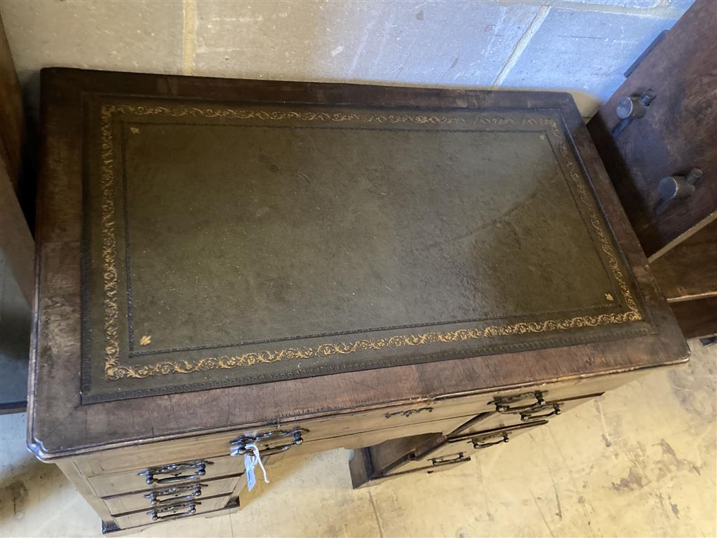 A Queen Anne style walnut kneehole desk, width 74cm, depth 44cm, height 77cm